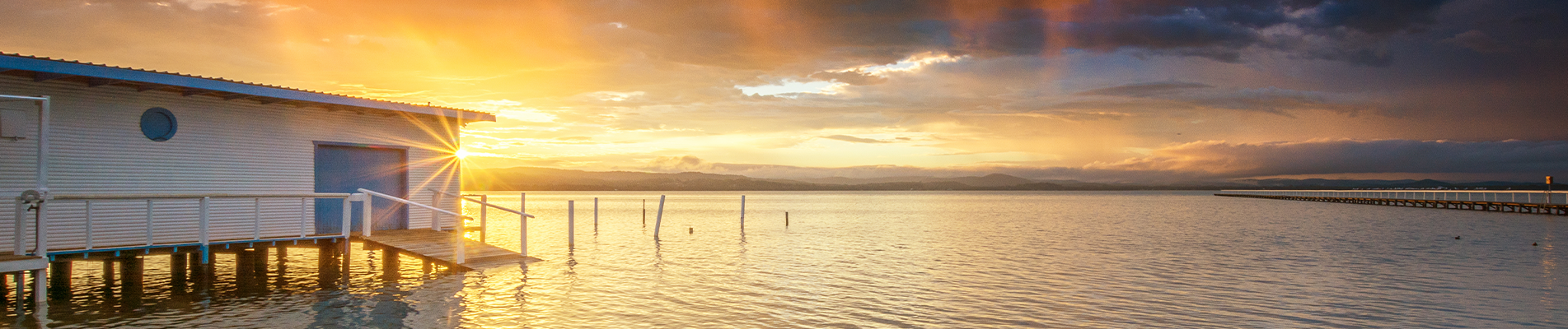 Long Jetty boat shed with a beautiful sunset